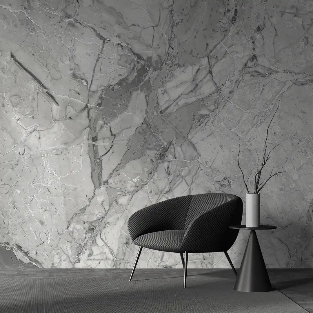 Modern black chair and side table against a textured stone wallpaper.