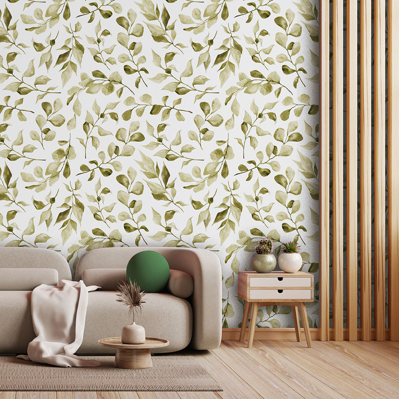 Living room with beige sofa, green decorative ball, and side table against a leaf wallpaper wall.
