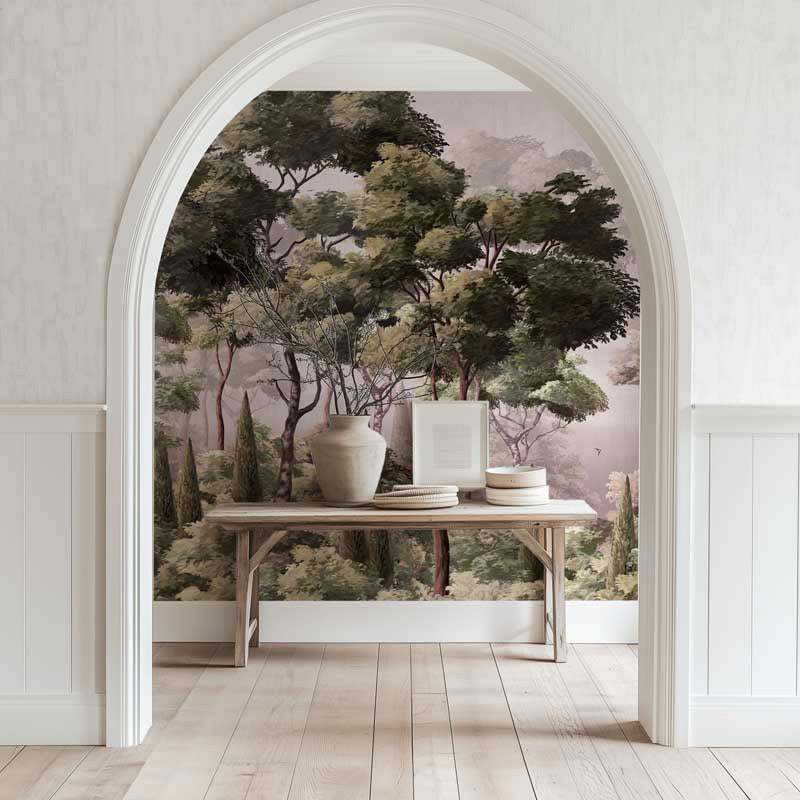 Room with a large archway featuring a forest mural, a table with decor items, and light wood flooring.