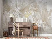 Wooden desk with chairs against a decorative banana leaf wallpaper.
