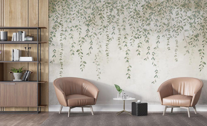 Modern living room with two brown armchairs, a small round table, and a decorative leaf wall wallpaper mural.