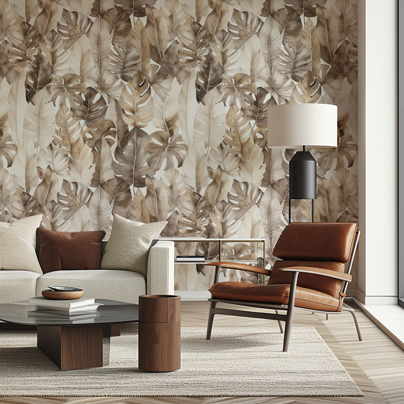 Modern living room with leaf wallpaper, brown leather chair, and white sofa.