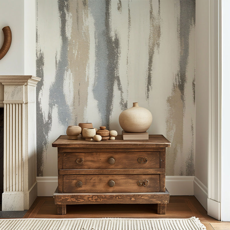 Wooden side table with decorative items against an abstract wallpaper