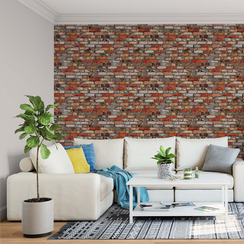 Living room with a white sofa, colorful cushions, and a brick wallpaper.
