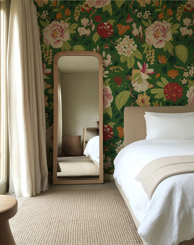 Bedroom with floral wallpaper, bed, and standing mirror.