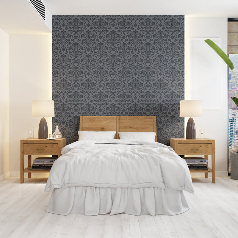 Modern bedroom with wooden bed and nightstands against a vintage wallpaper.