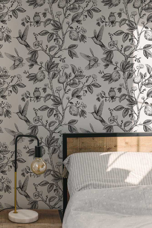 Bedroom with floral wallpaper and a lamp on a nightstand.