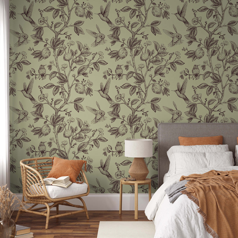 Bedroom with yellow floral wallpaper, bed, chair, and lamp.