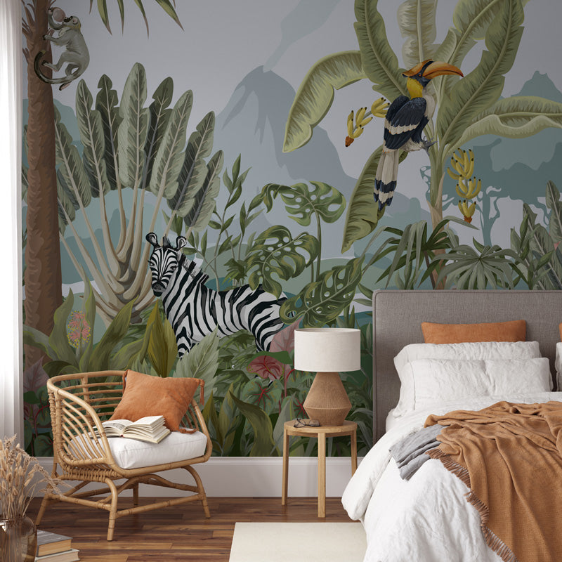 Jungle wall mural in a room with zebra, toucan, and other animals.