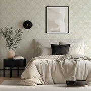 Modern bedroom with a bed, nightstand, and damask wallpaper.
