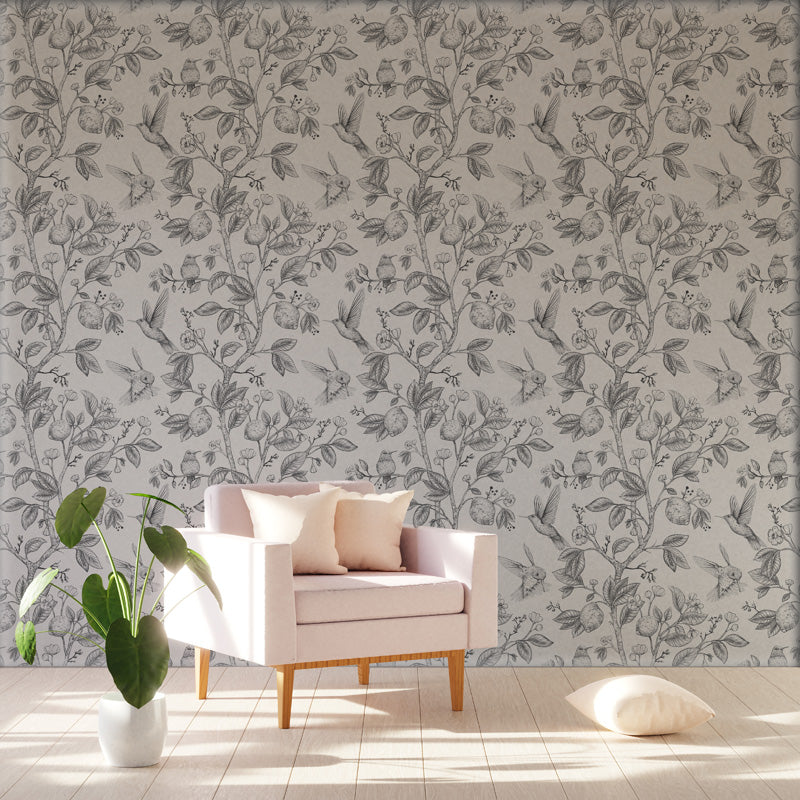 Living room with a floral wallpaper, pink armchair, and white floor.