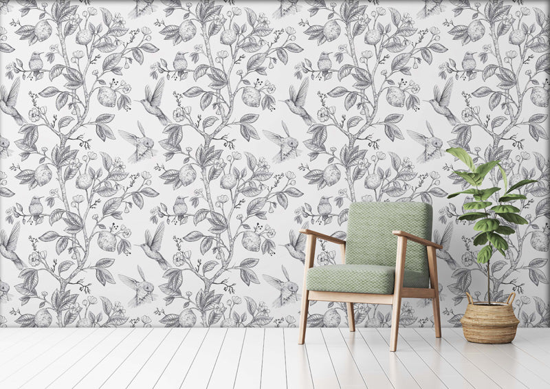 Chair with green cushion against a floral wallpaper.