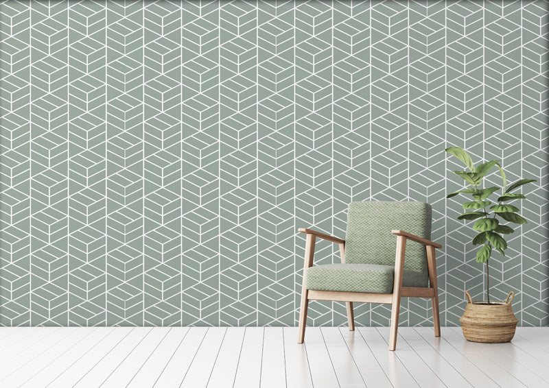 Green geometric wallpaper with a chair and plant in a room.