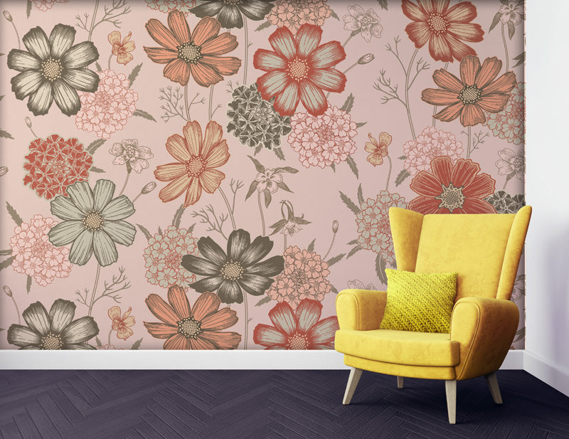 Yellow armchair with a green pillow against a floral wallpaper.