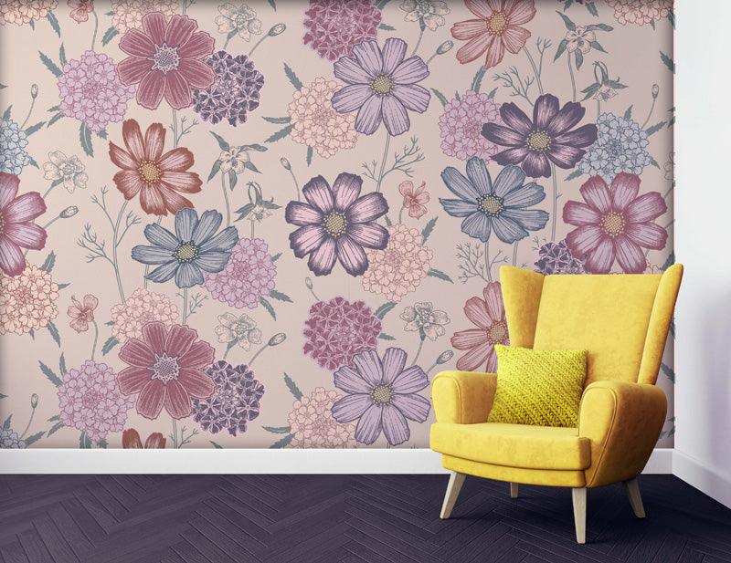 Yellow armchair with a green pillow against a floral wallpaper.