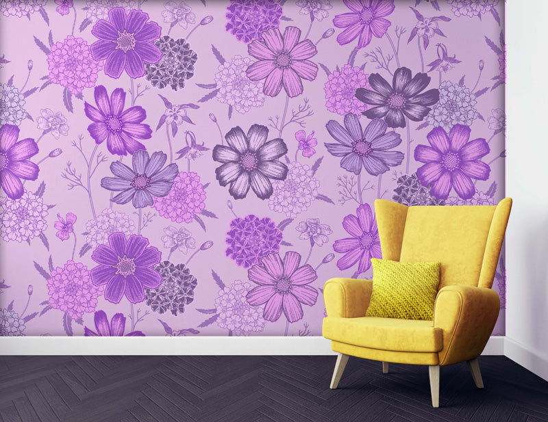 Yellow armchair with a green pillow against a purple floral wallpaper.