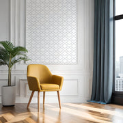 Yellow armchair in a modern room with a plant and large window and wallpaper.