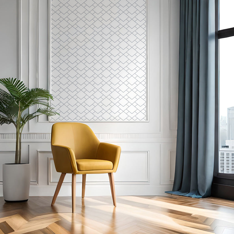 Yellow armchair in a modern room with a plant and large window and wallpaper.