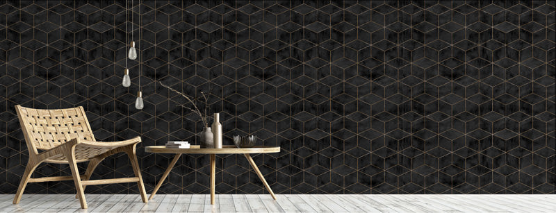 Modern interior with a wicker chair and wooden table against a black geometric tile wallpaper.