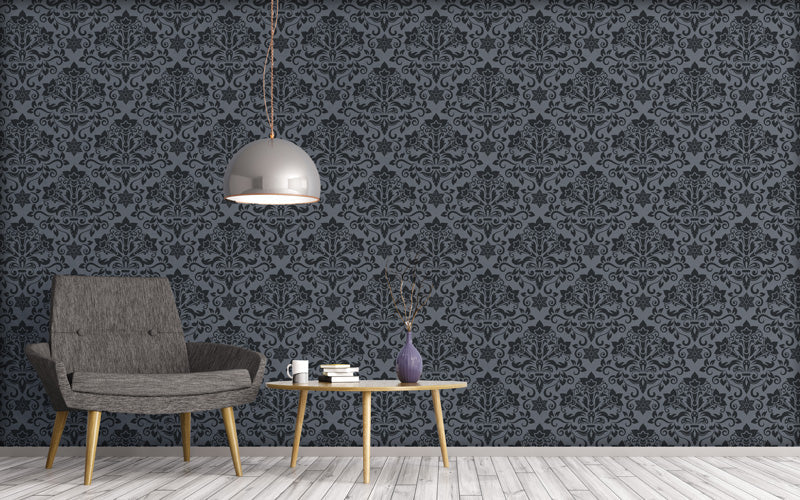 Living room with gray armchair, coffee table, and decorative items against a dark wallpaper.