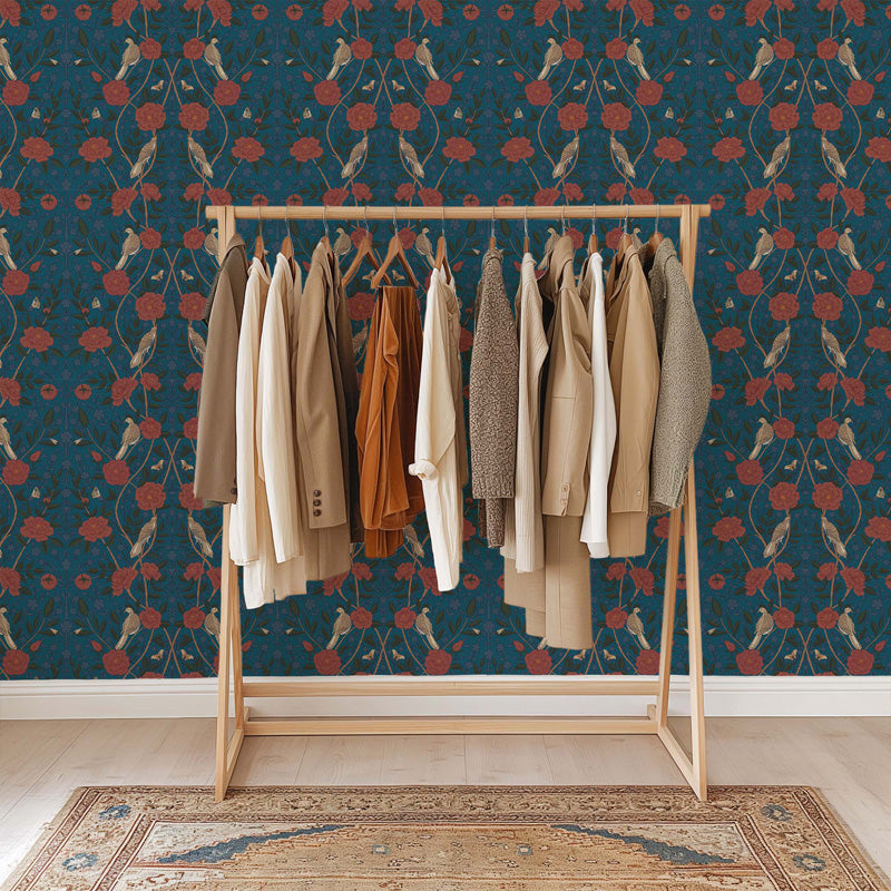 Wooden clothing rack with various jackets against a willian morris walpaper.