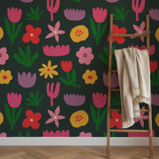 Colorful floral wallpaper with a wooden ladder and beige blanket.