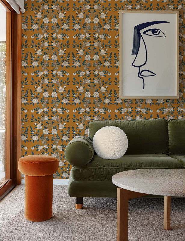 Living room with green sofa, orange stool, and floral wallpaper