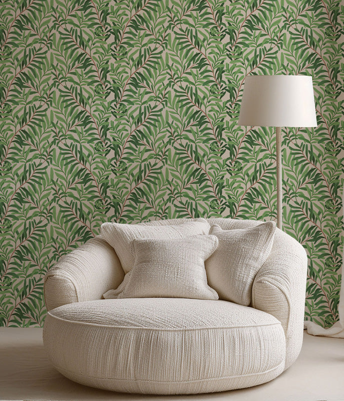 Beige armchair against a green leafy wallpaper with a lamp.