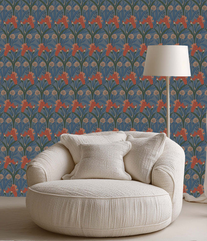Beige armchair against a blue wallpaper with a white floor lamp.