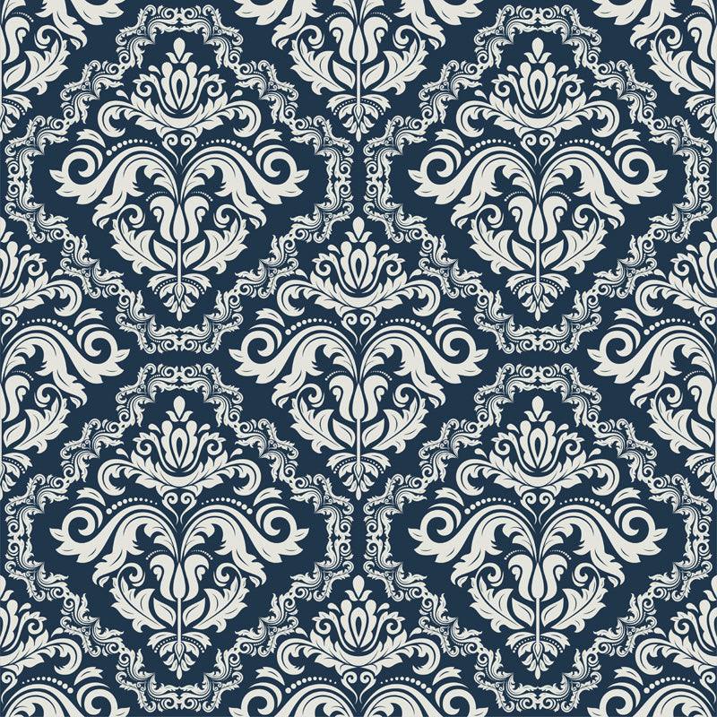 Decorative pattern with white flourishes on a dark blue wallpaper