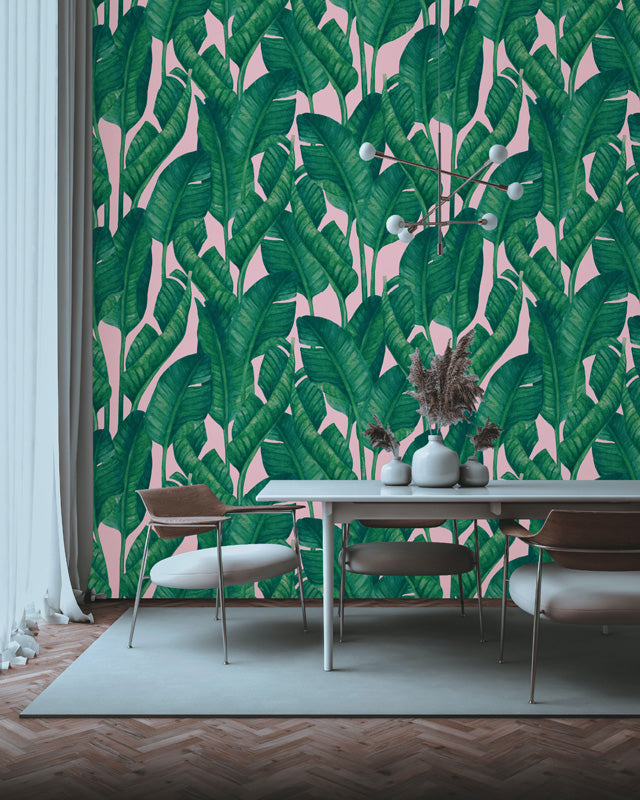 Dining room with a vibrant green leaf wallpaper and modern furniture.