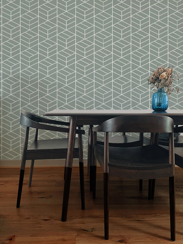 Dining area with a geometric wallpaper, table, and chairs.
