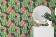 White dresser with decorative items against a tropical leaf wallpaper.