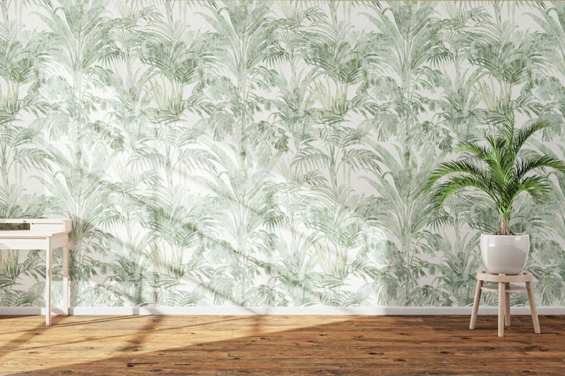 Room with a tropical leaf wallpaper, a plant on a stool, and a wooden floor.