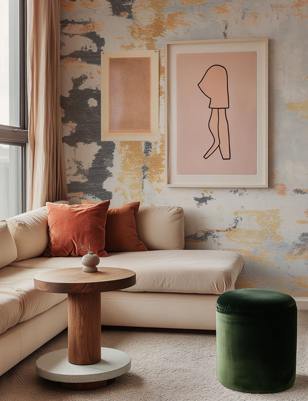 Modern living room with a beige sofa, wooden side table, and abstract wall art.