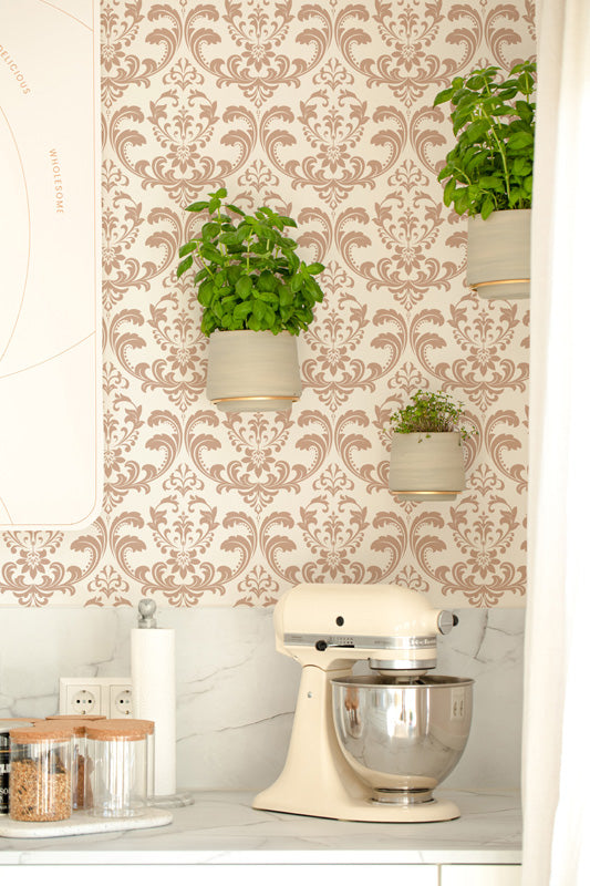 Kitchen scene with a stand mixer, decorative classic wallpaper, and potted plants.