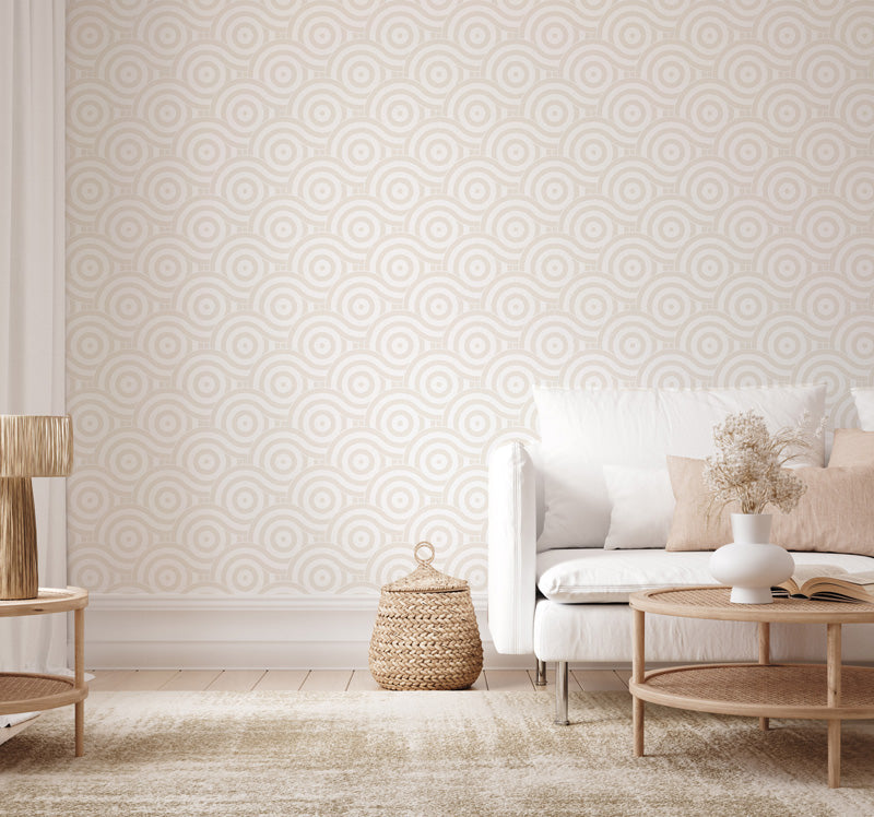 Living room with geometric wallpaper, white sofa, and wooden coffee table.