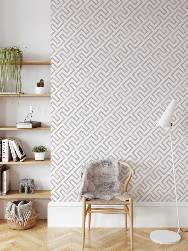 Room interior with geometric wallpaper, chair, and shelves.