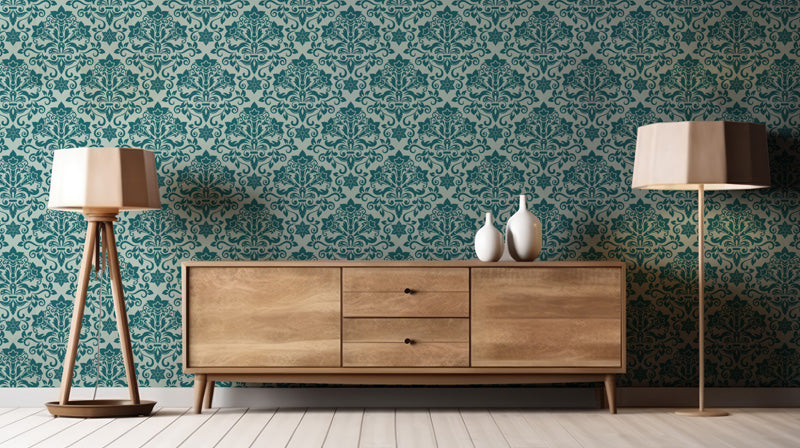 Wooden sideboard with two lamps against a blue wallpaper.