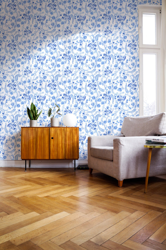Living room with floral wallpaper, wooden floor, and furniture.