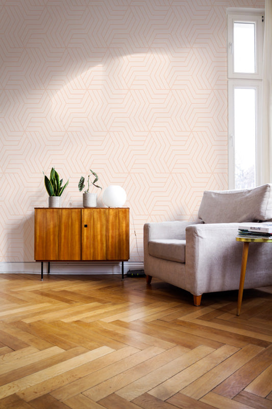 Living room with wooden floor, sofa, and sideboard against a pink wallpaper.