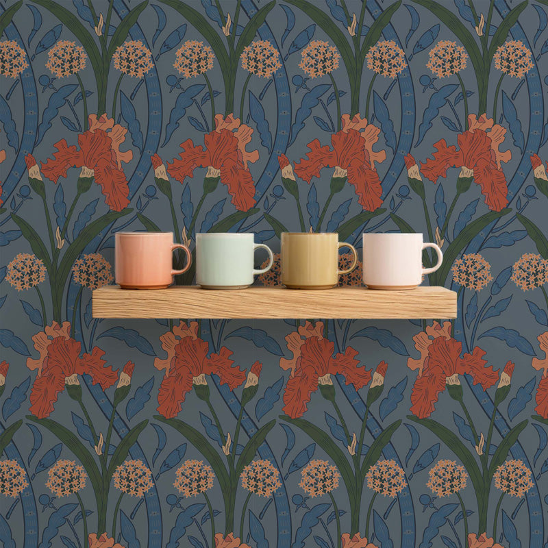 Four colorful mugs on a wooden shelf against a floral wallpaper background