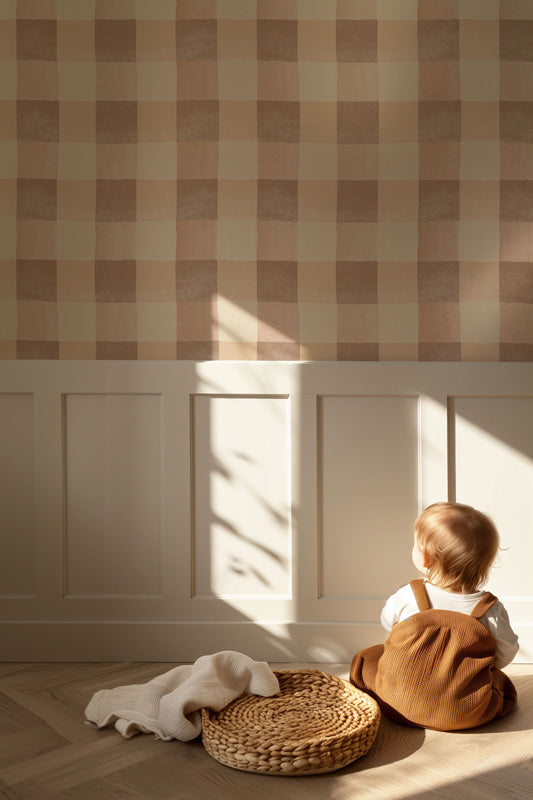 Child sitting on the floor in a sunlit room with checkered wallpaper