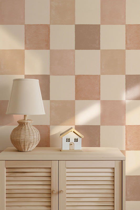 Checkered wallpaper with a lamp and decorative house on a wooden cabinet