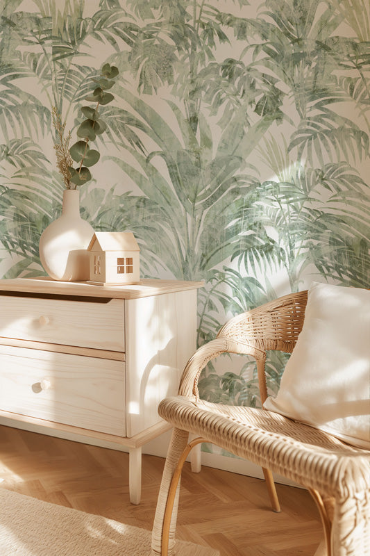 Room interior with a dresser and chair against a leaf wallpaper.