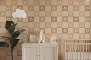 Nursery room with checkered wallpaper, cabinet, teddy bear, and crib.
