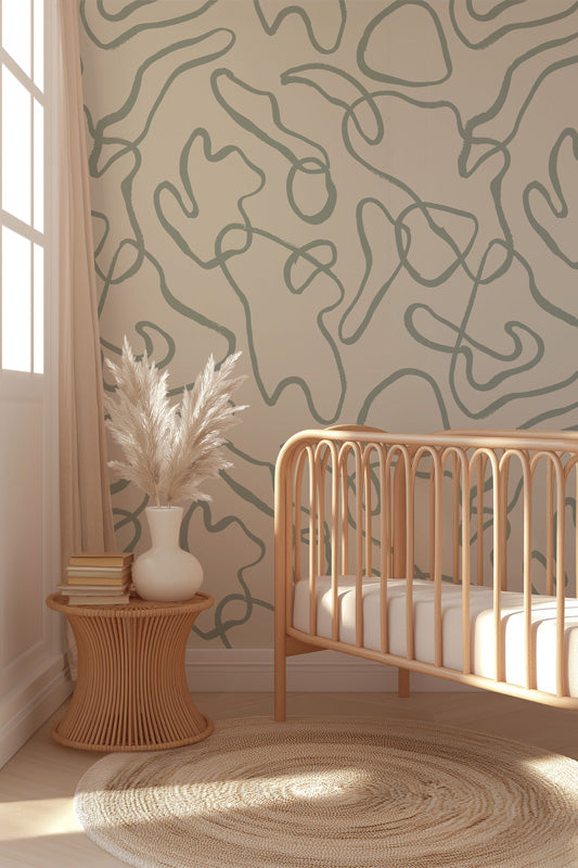 Nursery room with a crib, side table, and abstract blue wallpaper.