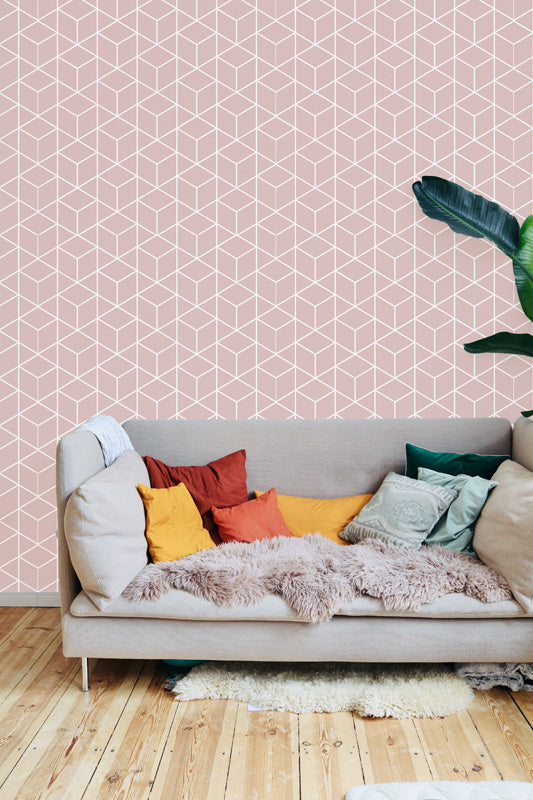 Living room with a beige sofa against a pink geometric wallpaper.