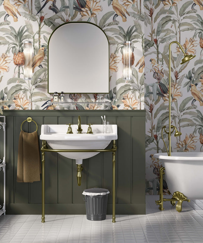 Bathroom interior with floral australian wallpaper, green paneling, and brass fixtures.