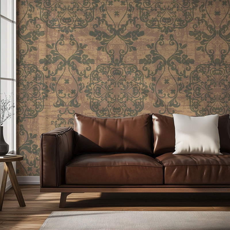 Brown leather sofa with decorative pillows against a vintage wallpaper.